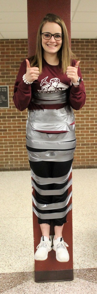 a female teacher taped to the wall