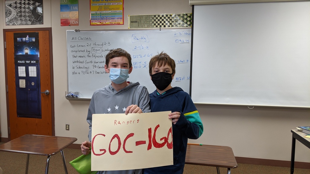 2 male students holding up a poster