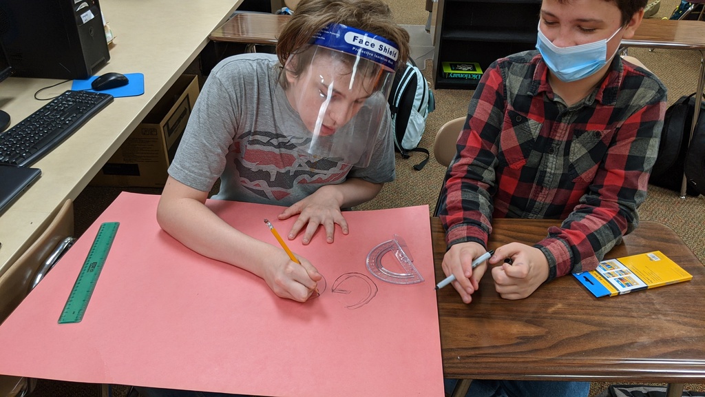 2 male students creating a poster