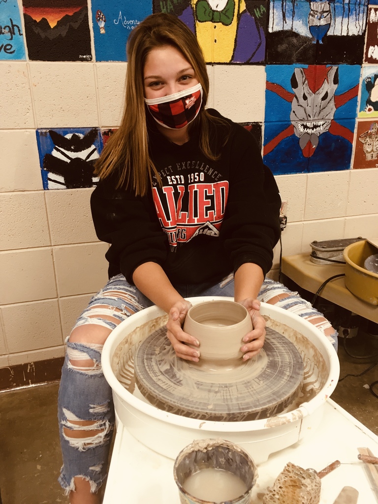female student on a pottery wheel