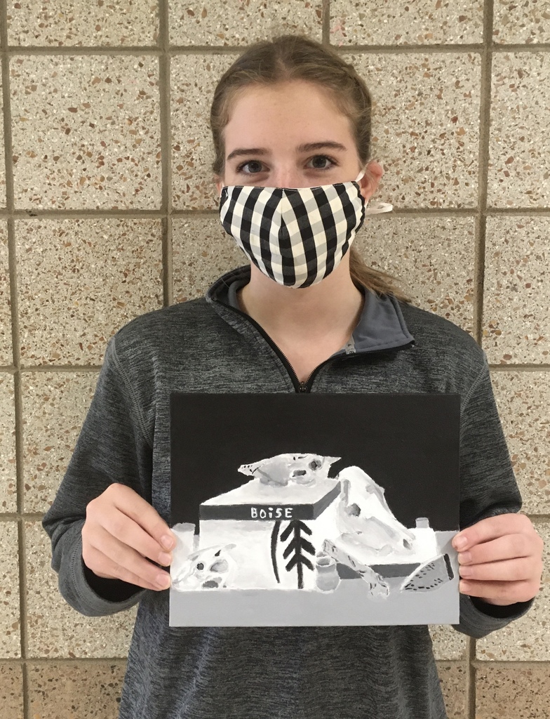 female student holding her black and white painting