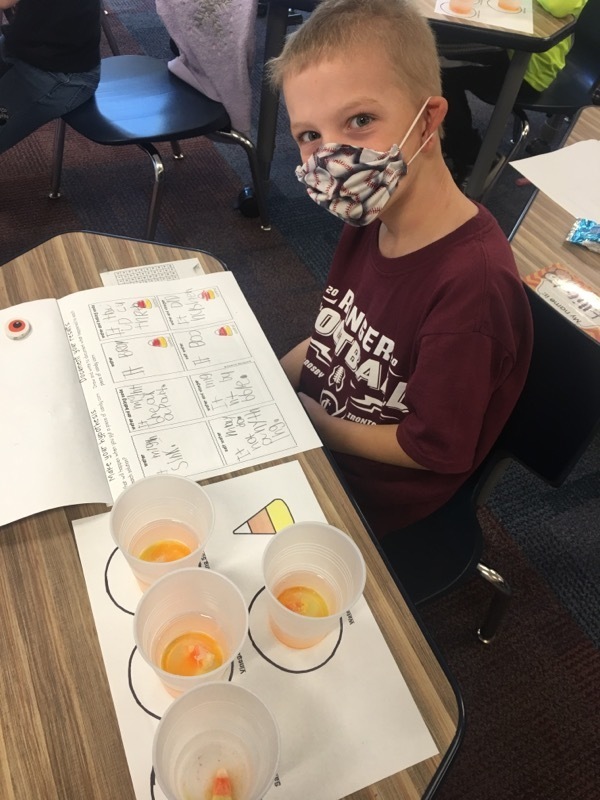 male student with a mask and candy corn