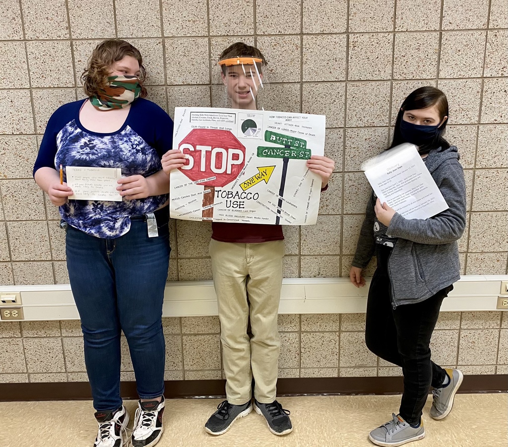 female and male students with a poster