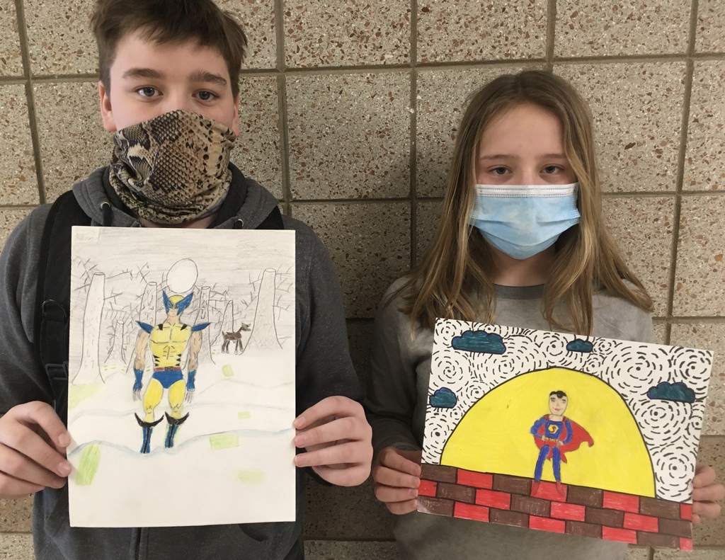 male and female student holding comic art