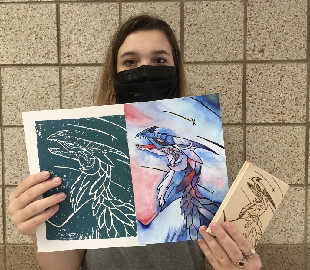 female with a mas holding 3 variations of a dragon drawing