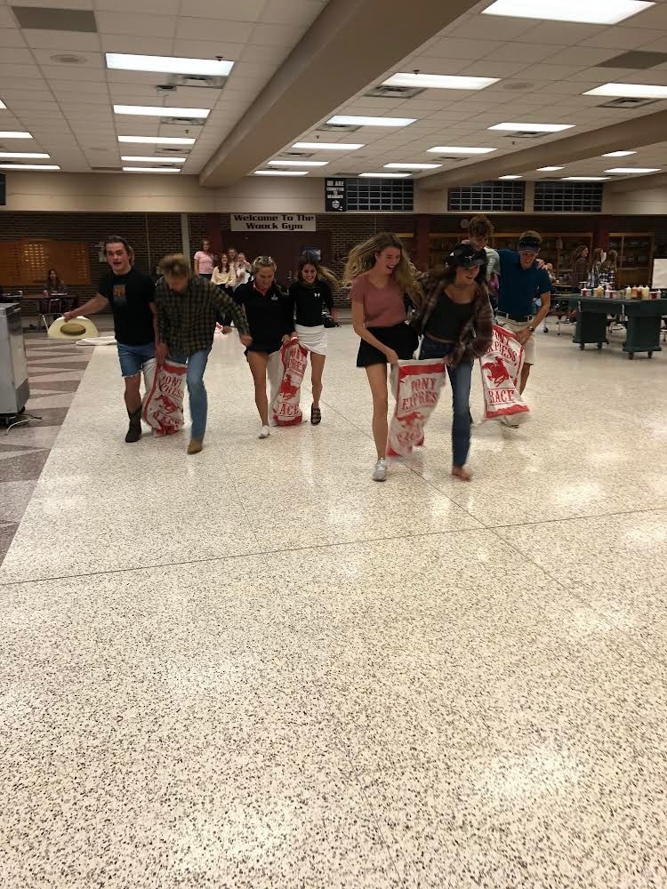 students in potato sack races