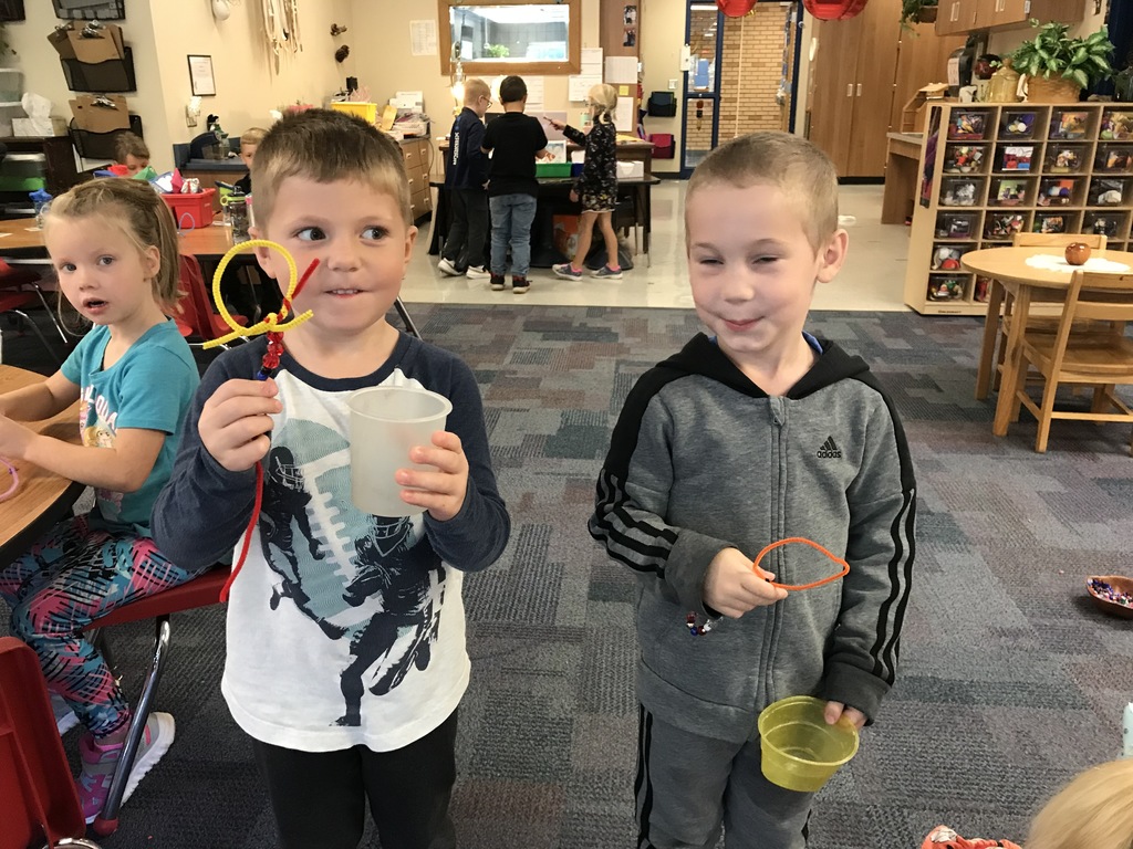 2 male students holding bubble wands