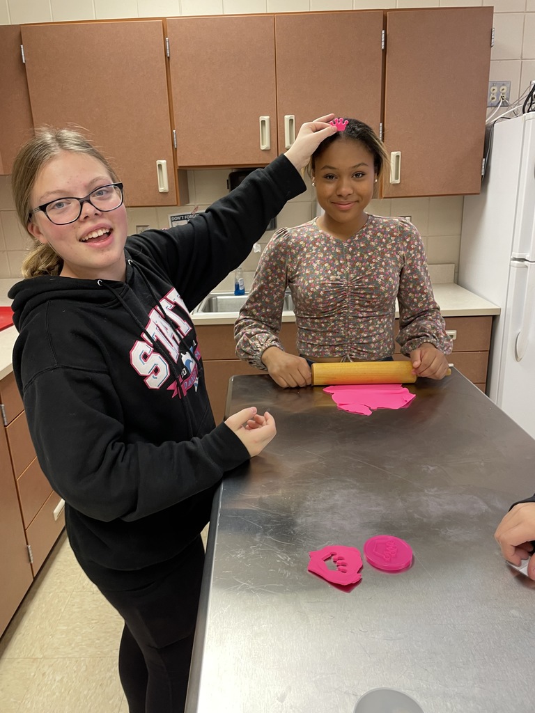 two females with pink playdough