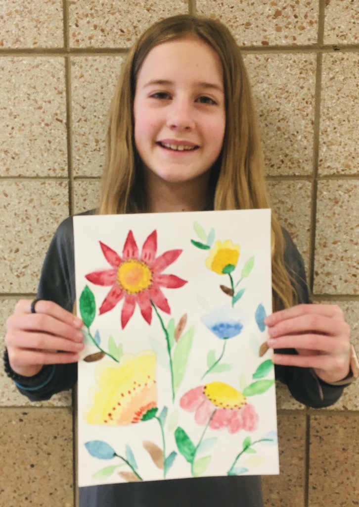 student holding a flower painting