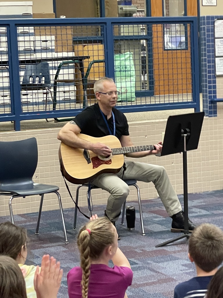 principal Becker with a guitar
