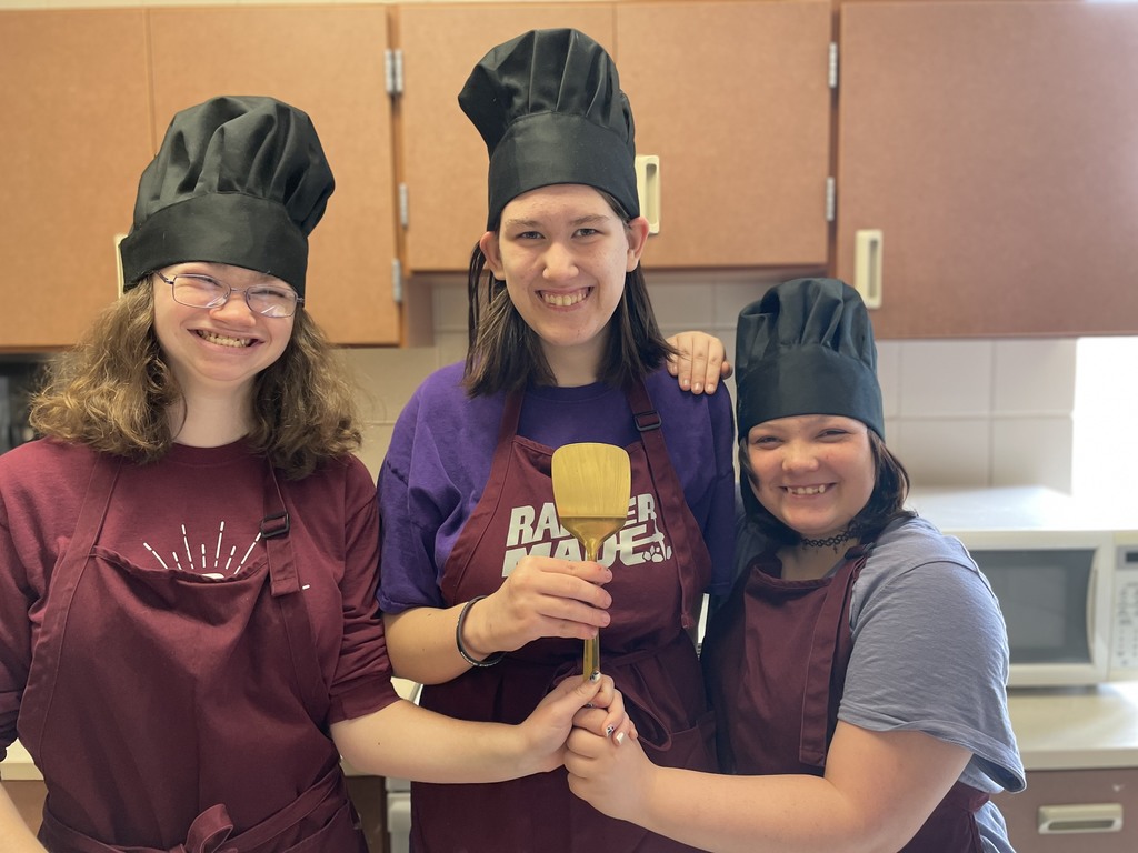 three students with chef hats 