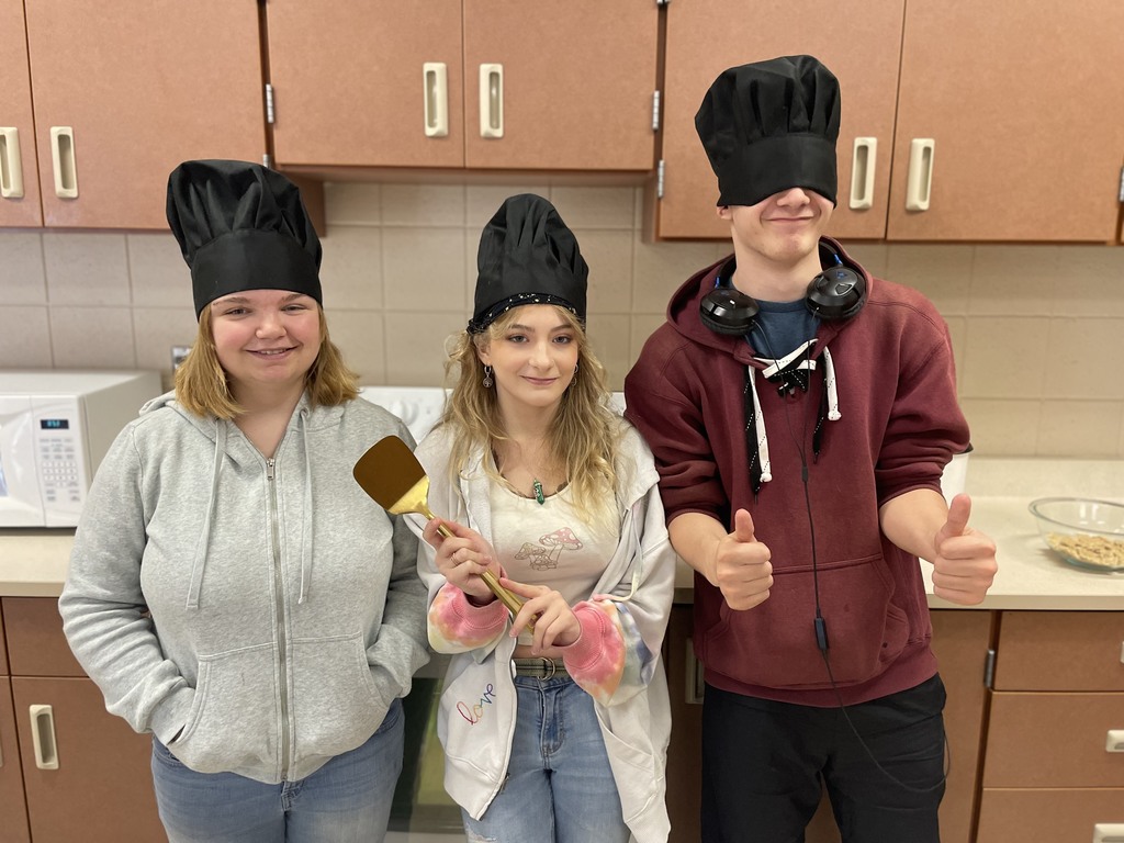 3 students with a spatula