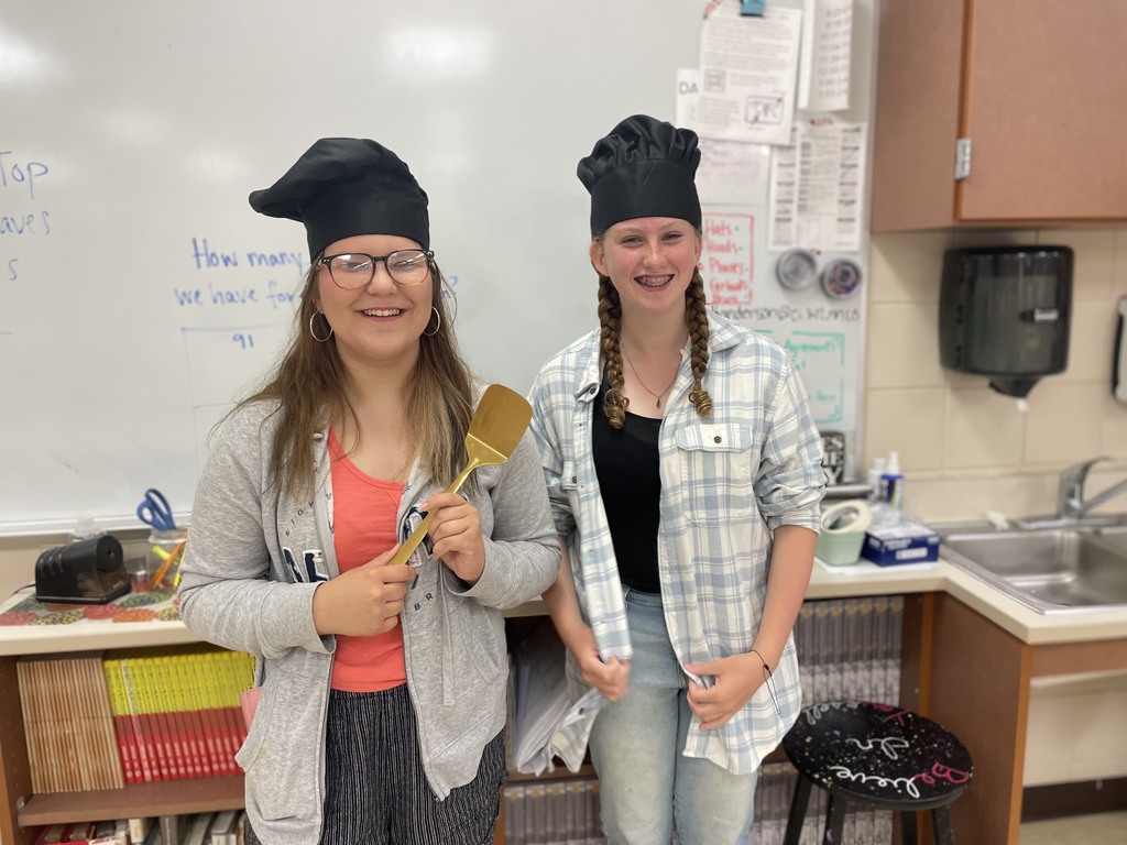 2 students with a golden spatula