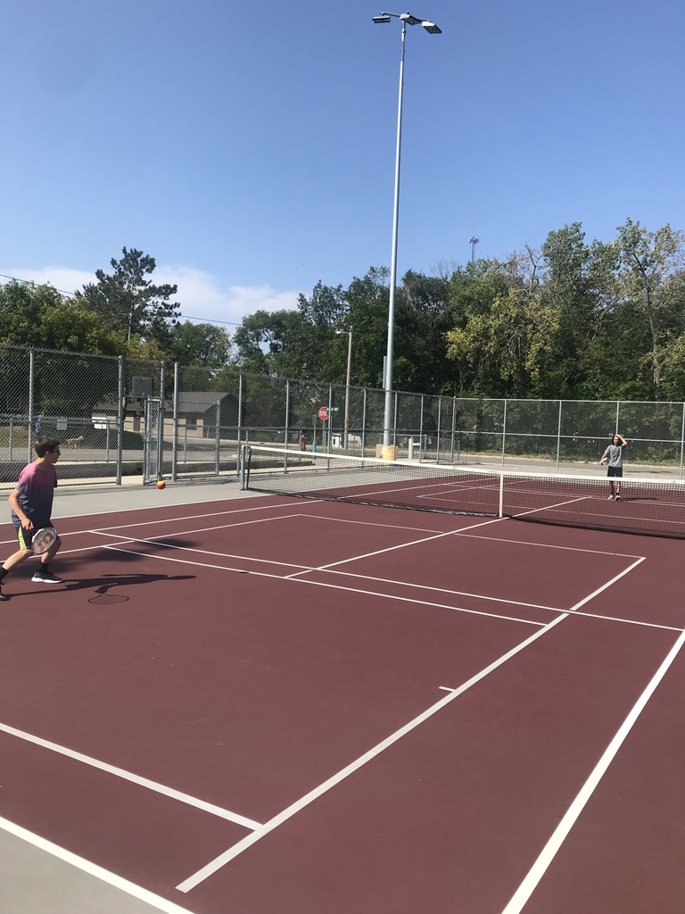 two students on the tennis courts