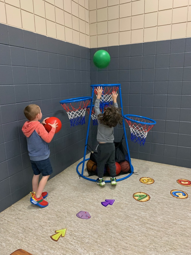 students shooting baskets