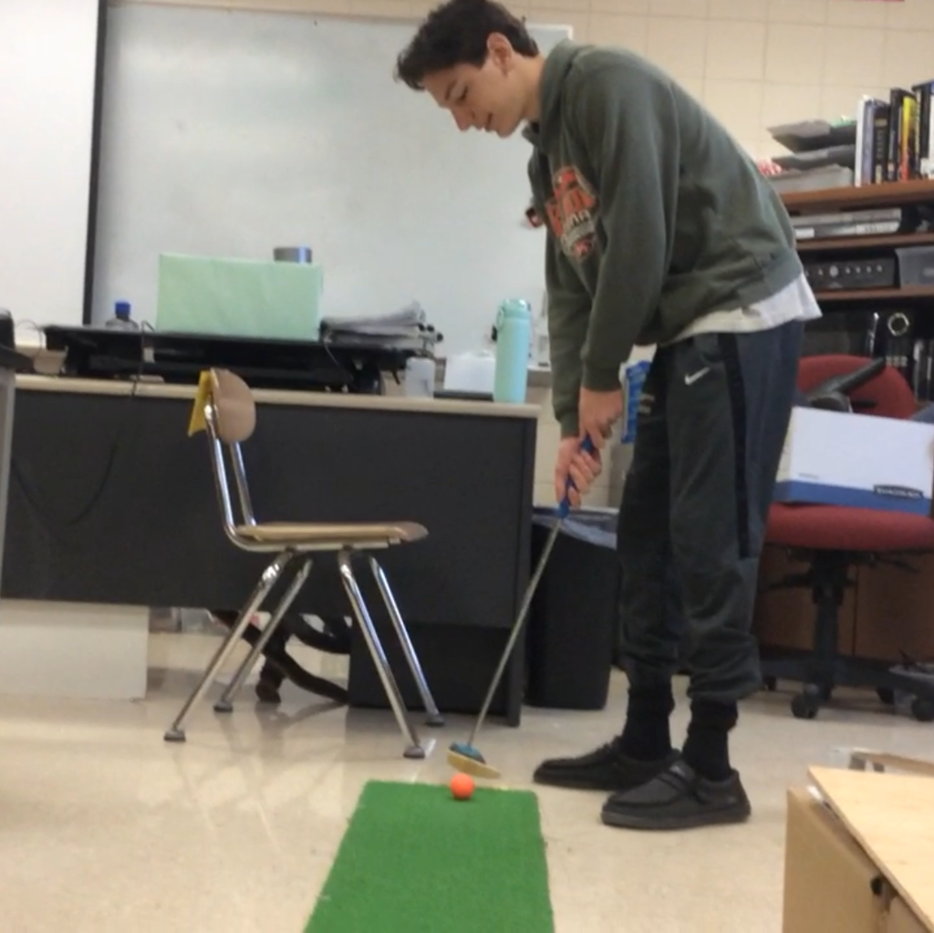 male student with a golf club