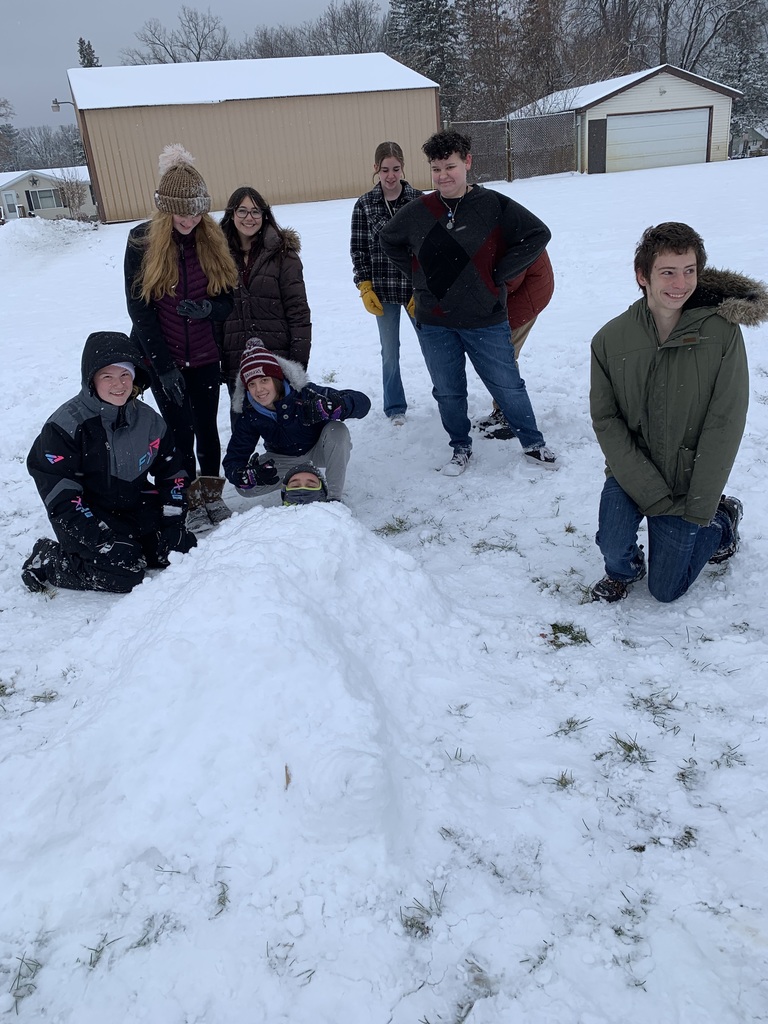 students around a body in the snow