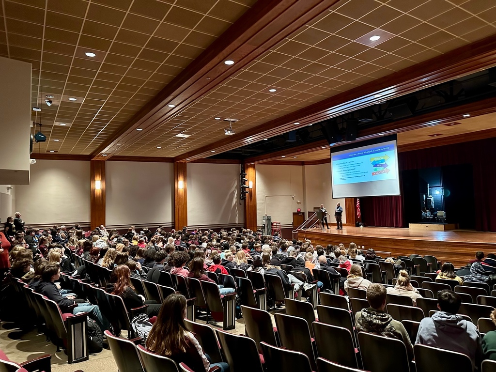 students filling seats in auditorium