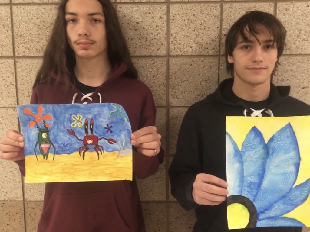students holding water color painting