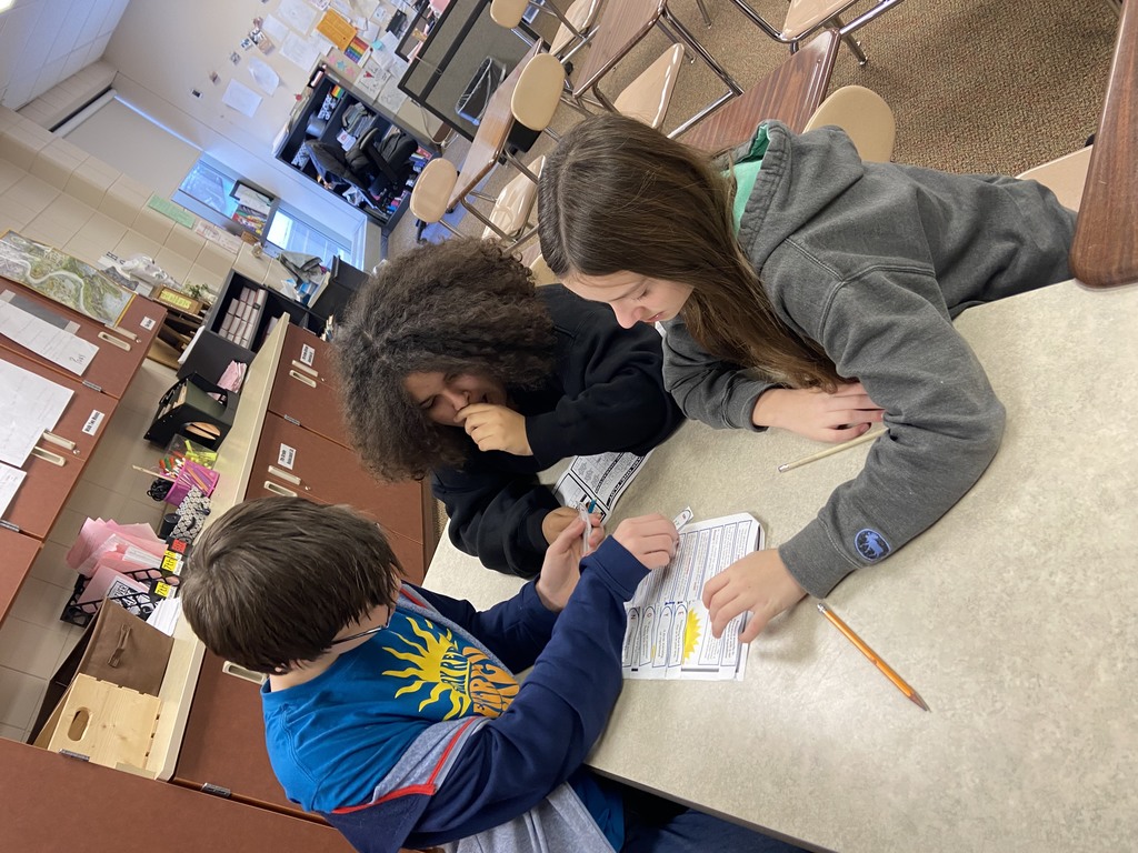 3 students working on a paper