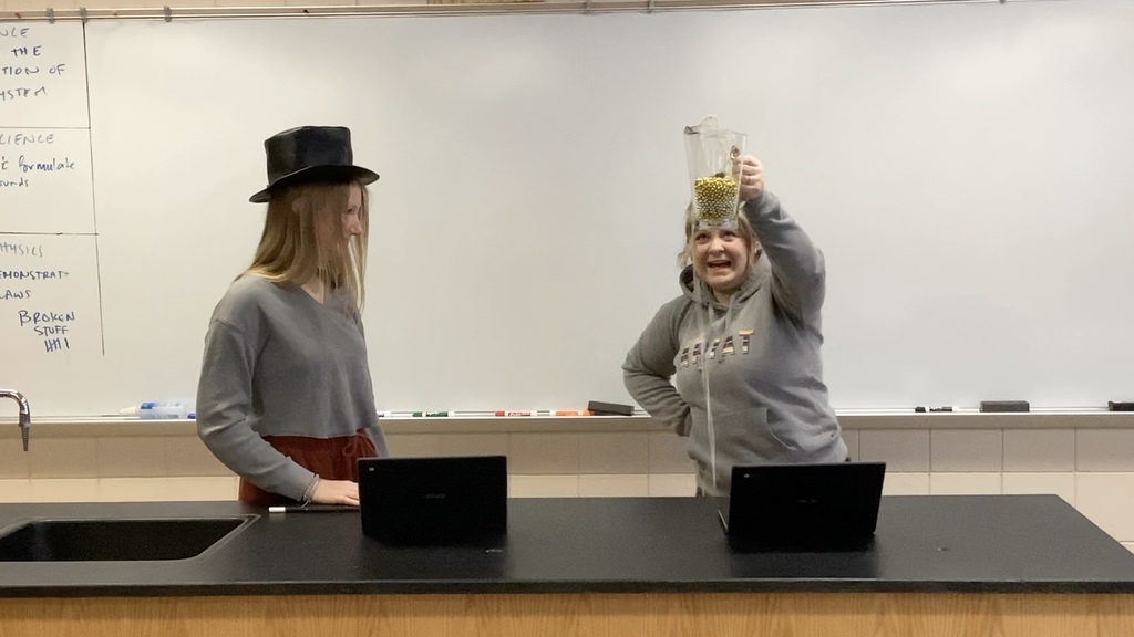 two students one with a hat on
