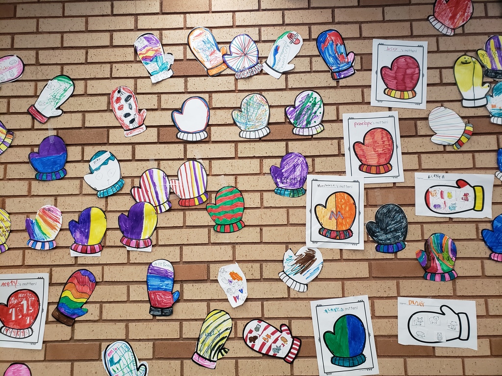 decorated mittens hung on brick