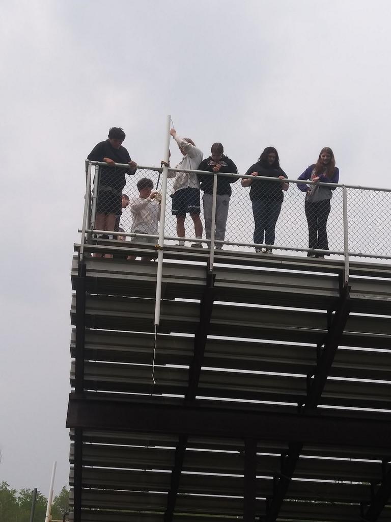 6 students on top of bleachers