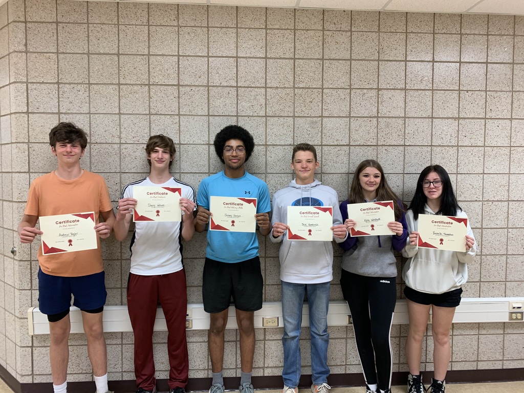6 students holding papers