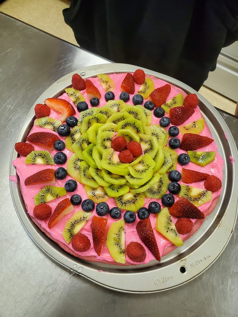fruit pizza with pink frosting