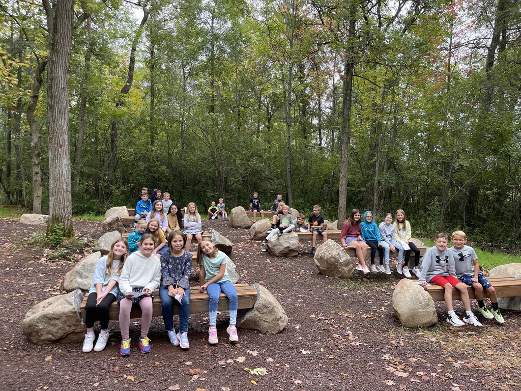 students sitting on benches outside