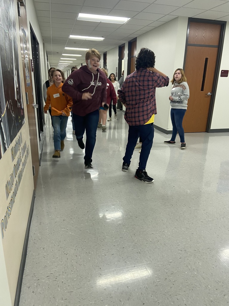 students running in a hallway