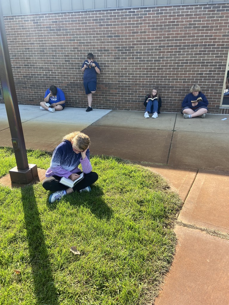 5 students outside reading