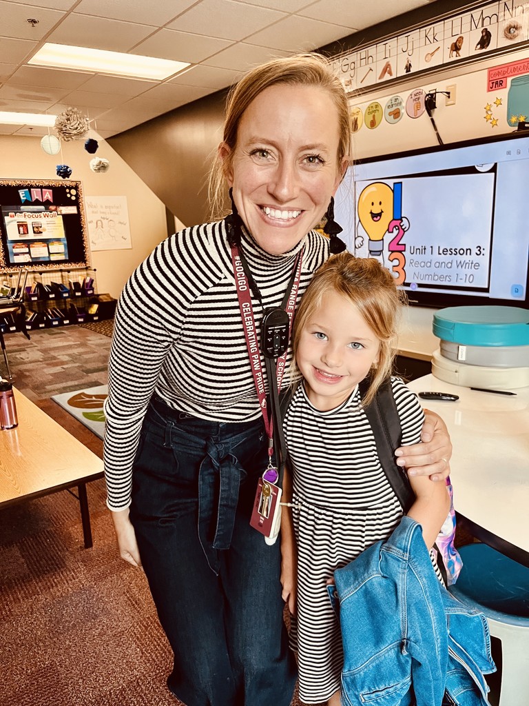 teacher in stripes with a student in stripes