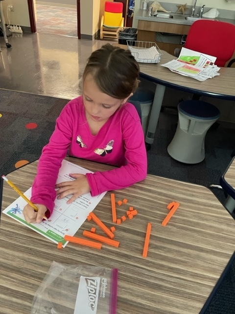 a girl with a pencil in her hand