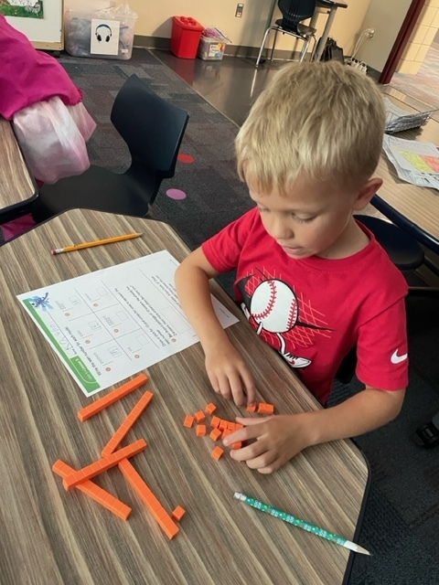 a boy counting orange cubes
