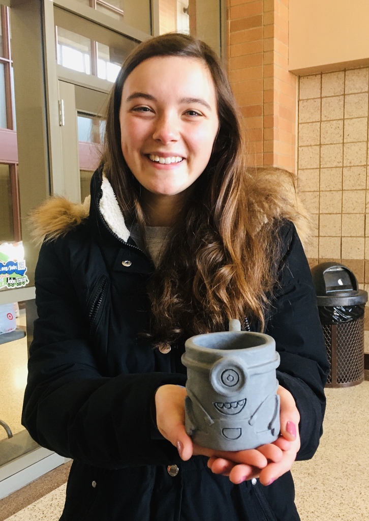 female student with a minion mug that she made