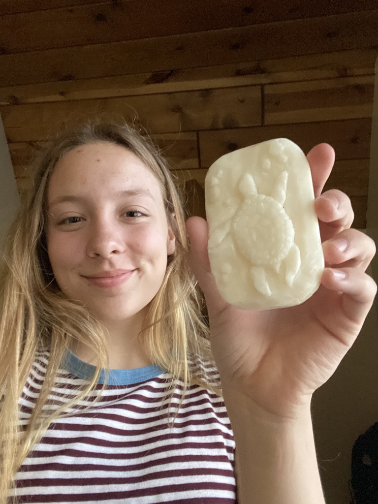 female student with a soap carving of a turtle